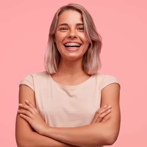 Girl smiling with happiness after getting braces.